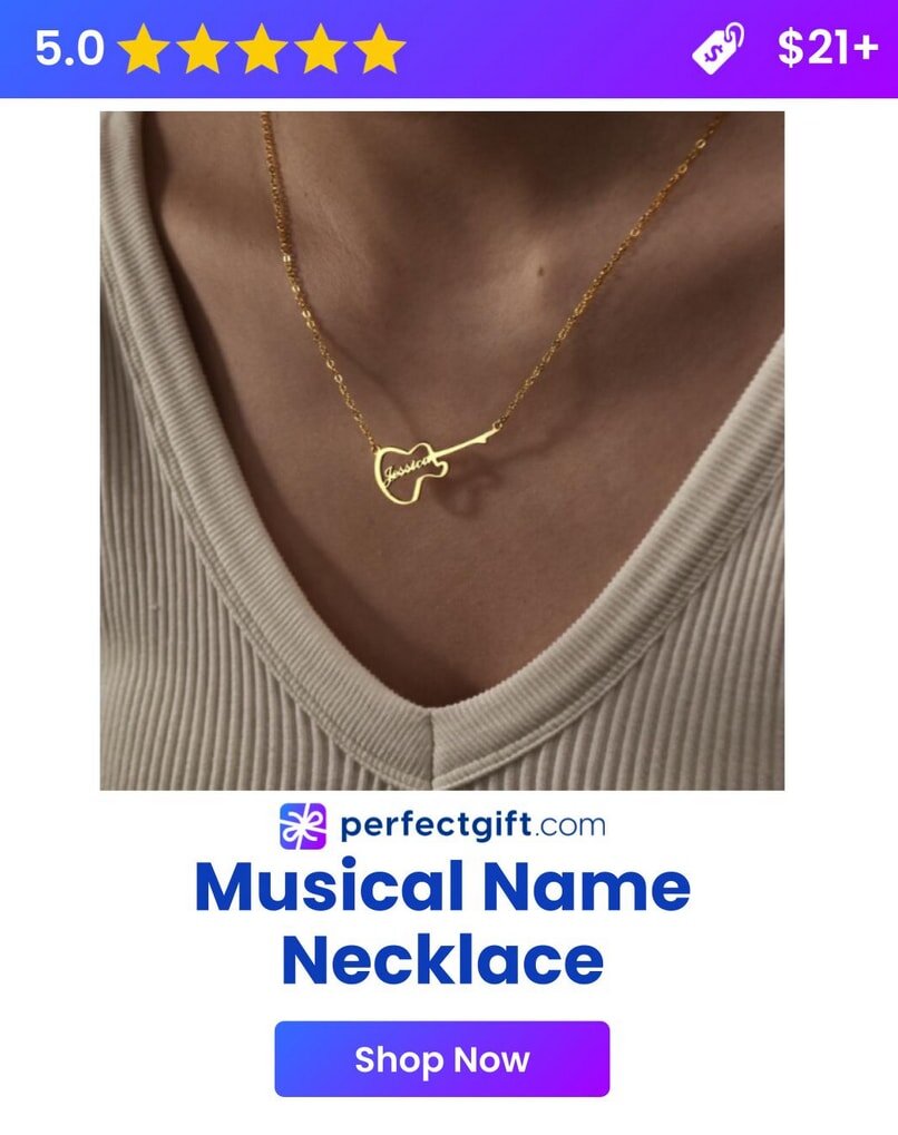 A gold necklace shaped like a guitar hangs around a person's neck, with a cursive name. 