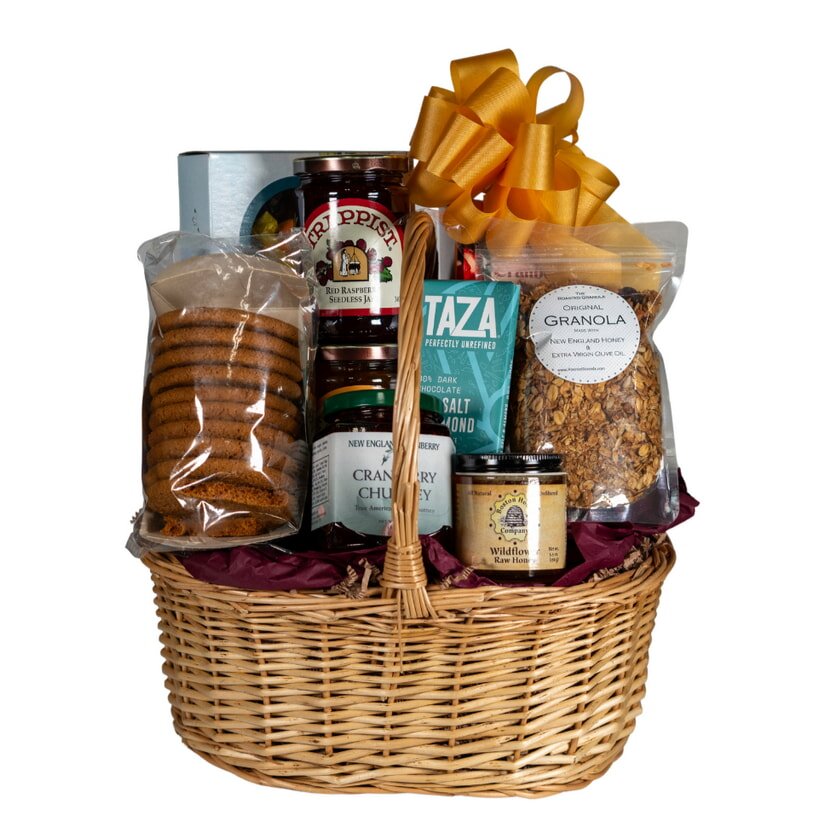 A wicker basket filled with assorted cookies, crackers, and snacks arranged neatly for display.