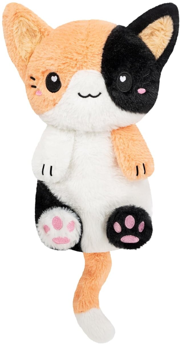 A stuffed cat featuring a mix of black, white, and orange fur, sitting upright with a playful expression.