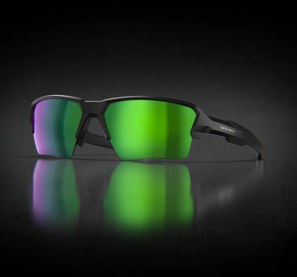 Oakley sunglasses with green lenses displayed against a solid black background.