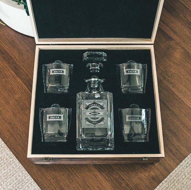 A bottle of whiskey displayed inside a polished wooden box, showcasing its elegant packaging and craftsmanship.