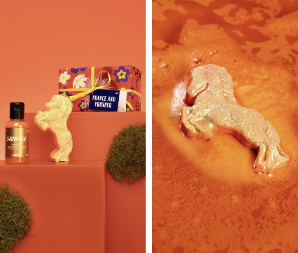 Golden unicorn bath bomb and orange bottle on a pedestal against an orange background, next to a gift box. Right: Unicorn in a shimmering orange liquid.