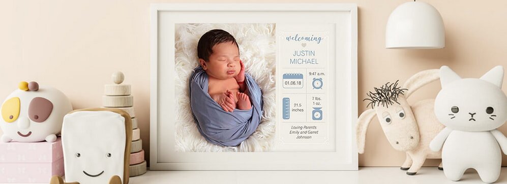 A framed baby announcement features a peacefully sleeping infant swaddled in a blue blanket, with birth details. Soft toys and pastel decor create a warm, cozy ambiance.