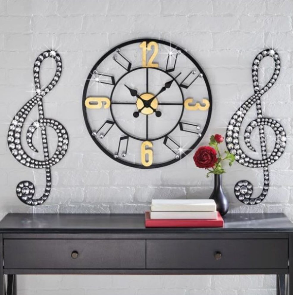 Wall clock with music notes and red rose vase on console table
