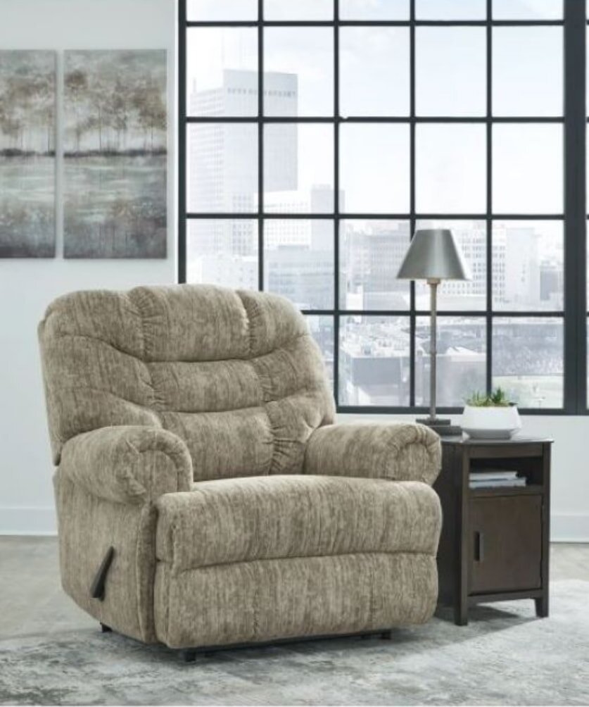 A vibrant crowd in a stadium waves yellow and purple flags, creating a lively atmosphere during an event.