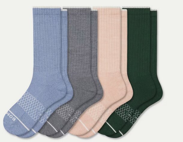 Five pairs of colorful socks displayed together, showcasing a variety of patterns and hues.
