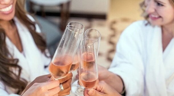 A vibrant crowd in a stadium waves yellow and purple flags, creating a lively atmosphere during an event.