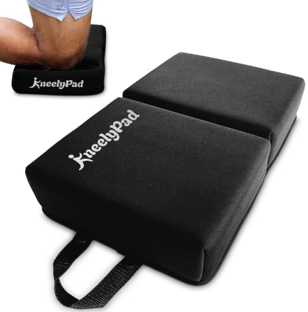 A man kneels on a knee pad, wearing a pair of black knee pads for protection while working or engaging in an activity.