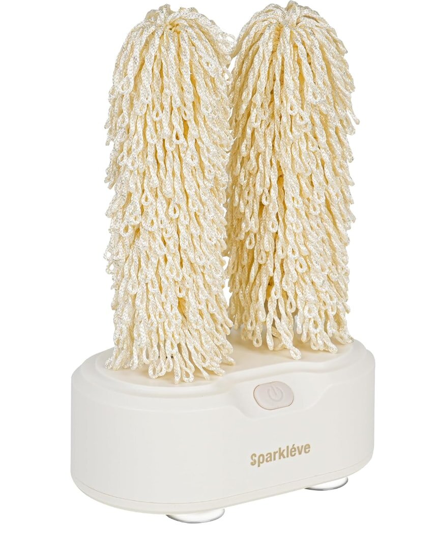 Electric mop with two white microfiber heads on charging base