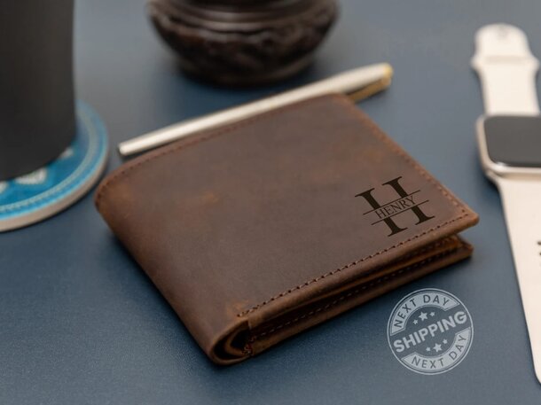 Personalized leather wallet featuring embossed initials on the front, showcasing a sleek and elegant design.