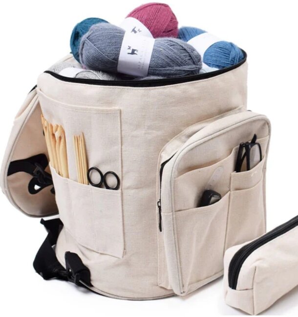 A bag containing knitting needles and colorful yarn, ready for a crafting project.