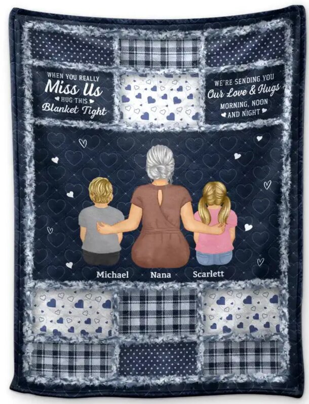 A cozy blanket with two children snuggled up alongside their mother, creating a warm family moment.