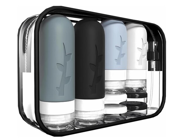 A stylish black and white travel case featuring four organized bottles for travel convenience.