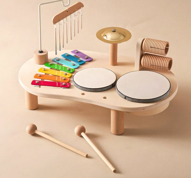 A colorful wooden toy set featuring various musical instruments, including a drum, designed for children's play and exploration.