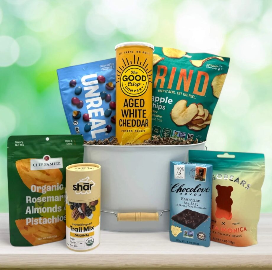 Assorted snacks arranged around a white bowl on a table