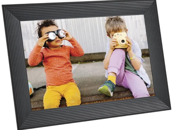 Two children sit on a bench, holding a camera and smiling, ready to capture moments together.