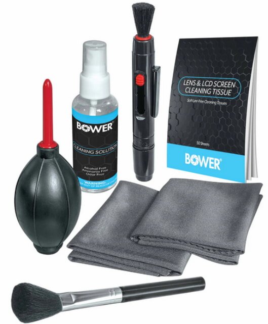 A power tool kit featuring a cleaning cloth, a brush, and an instructional book for maintenance and care.