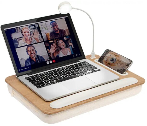 A laptop on a wooden desk accompanied by a smartphone and a tablet, creating a modern workspace setup.