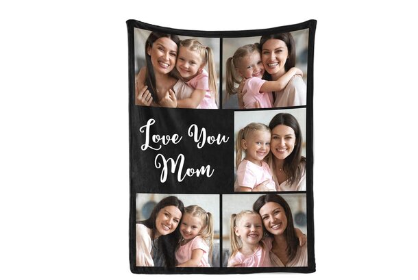 A black beach towel featuring the phrase "Love You Mom" in bold, white letters.
