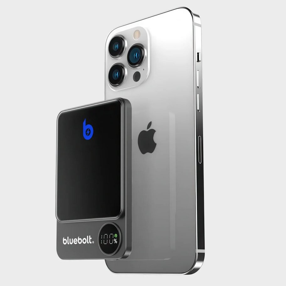The new iPhone 11 displayed next to a sleek Bluetooth speaker on a wooden surface.