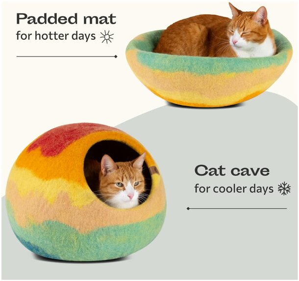 Two cats are comfortably sitting together inside their cozy cat cave.