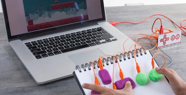 A person seated at a desk, operating a computer with a mouse and keyboard.