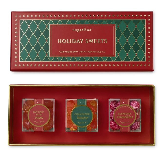 Sugarfina Holiday Sweets box with three candy types: Rosé Roses, Champagne Bears, and Raspberry Crunchies in festive packaging.