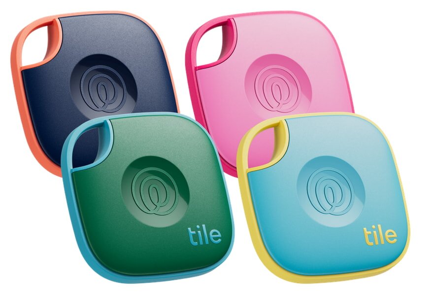 Four colorful GPS tracking devices are displayed: navy with orange trim, pink, green with blue trim, and blue with yellow trim. Each has a small circular logo.