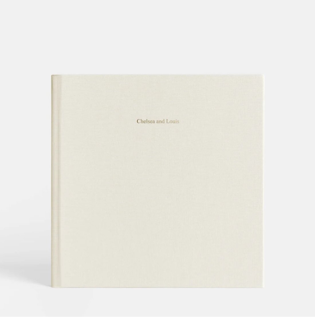A white notebook featuring the words "proud" and "love" in elegant lettering on the cover.