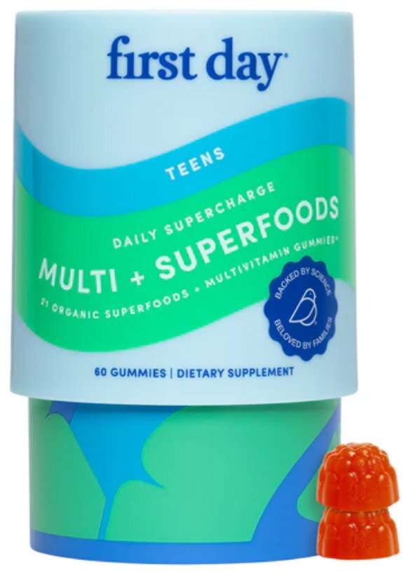 A colorful assortment of multi and superfood supplements displayed on a wooden table, emphasizing health and wellness.