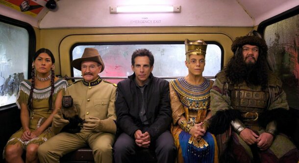 Four people sitting together on a train, engaged in conversation and enjoying their journey.