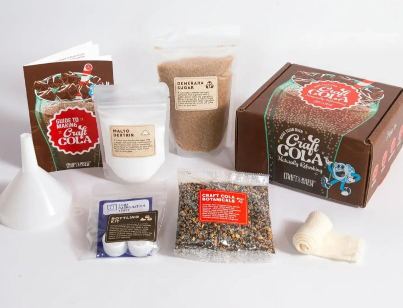 A display of ingredients for a chocolate making kit, including cocoa powder, sugar, and molds.