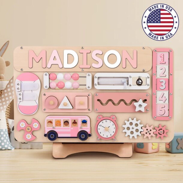 A wooden toy featuring the name "Madison" carved on its surface.