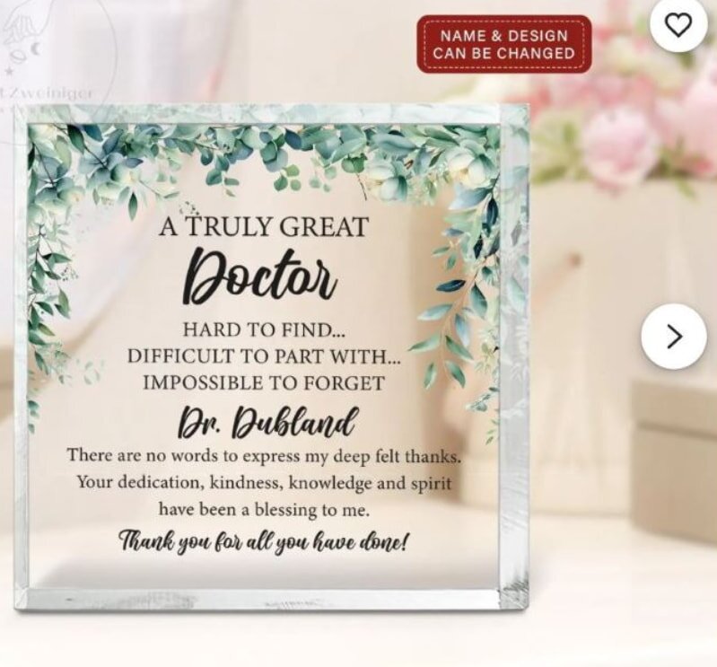 A baked breakfast casserole in a white dish on a wooden surface, featuring melted cheese, bacon, and vegetables. Nearby, a red oven mitt adds a vibrant touch.