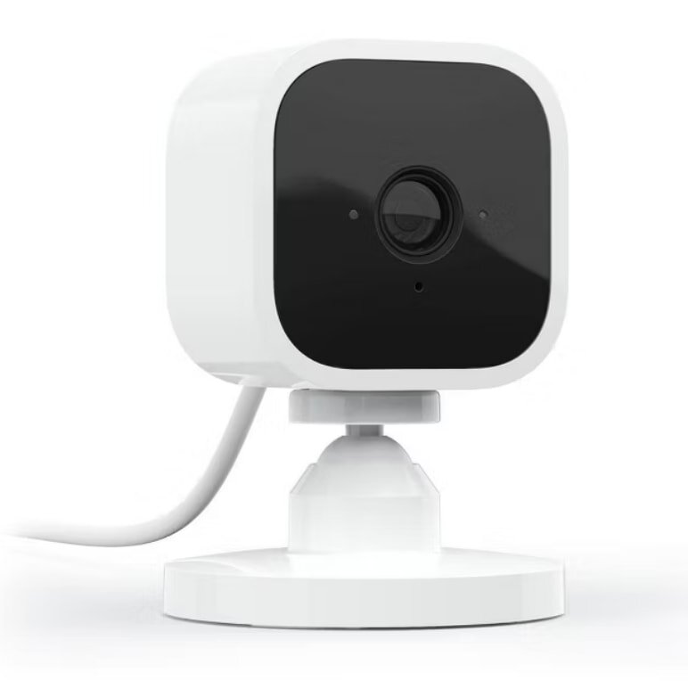 A white security camera mounted on a wall, designed for surveillance and monitoring purposes.
