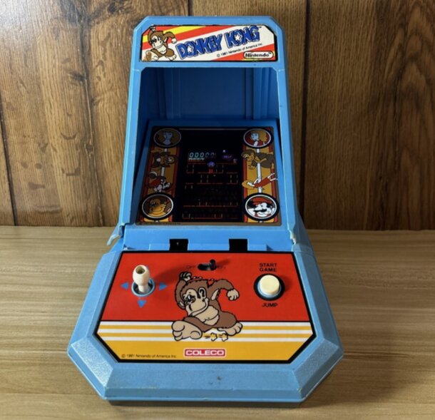 A vintage arcade game displaying a playful monkey on the screen, evoking nostalgia for classic gaming experiences.