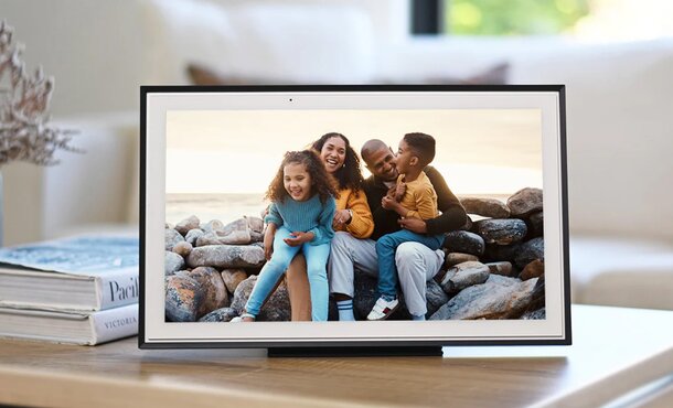 A family photo displayed on a tablet resting on a table, showcasing joyful moments together.  