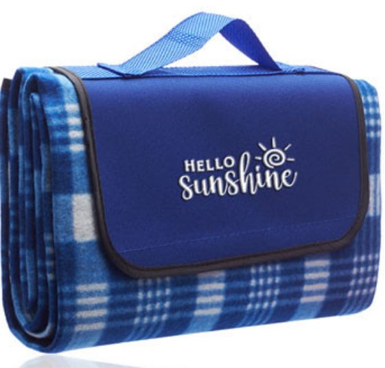 Folded blue plaid picnic blanket with a handle. The flap reads "Hello Sunshine" with a sun icon, conveying a cheerful outdoor vibe.