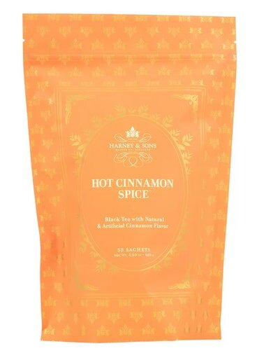 Orange Harney & Sons Hot Cinnamon Spice tea pouch with gold floral design, containing 50 black tea sachets with cinnamon flavor.