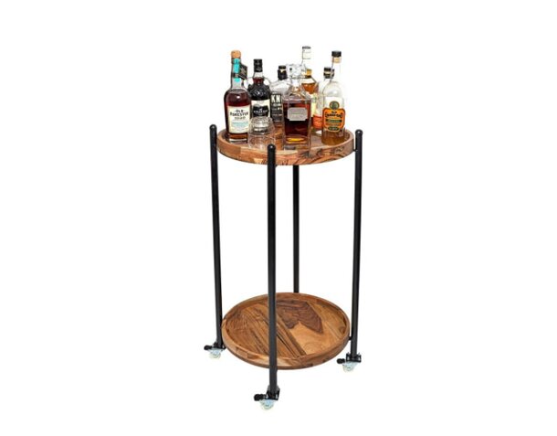  A stylish wooden bar cart featuring an assortment of bottles on top and shelves below.