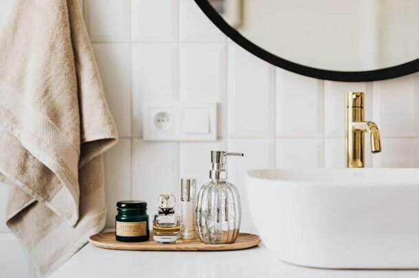 A clean bathroom sink with a towel and a bar of soap placed on the countertop.