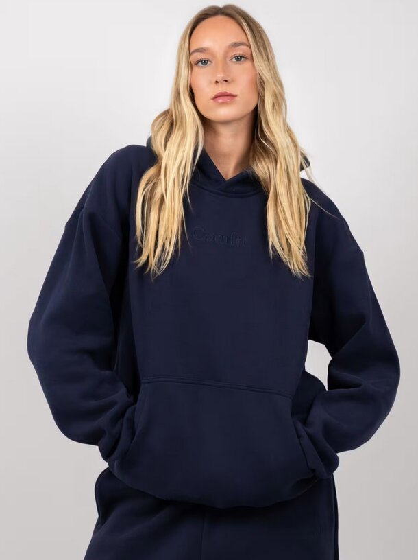 Women's navy hoodie sweatshirt paired with matching sweatpants, showcasing a casual and comfortable outfit.