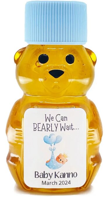 A honey bear-shaped bottle with a blue cap, featuring a label saying "We Can BEARLY Wait... Baby Kanno March 2024," adorned with a cheerful teddy bear illustration.