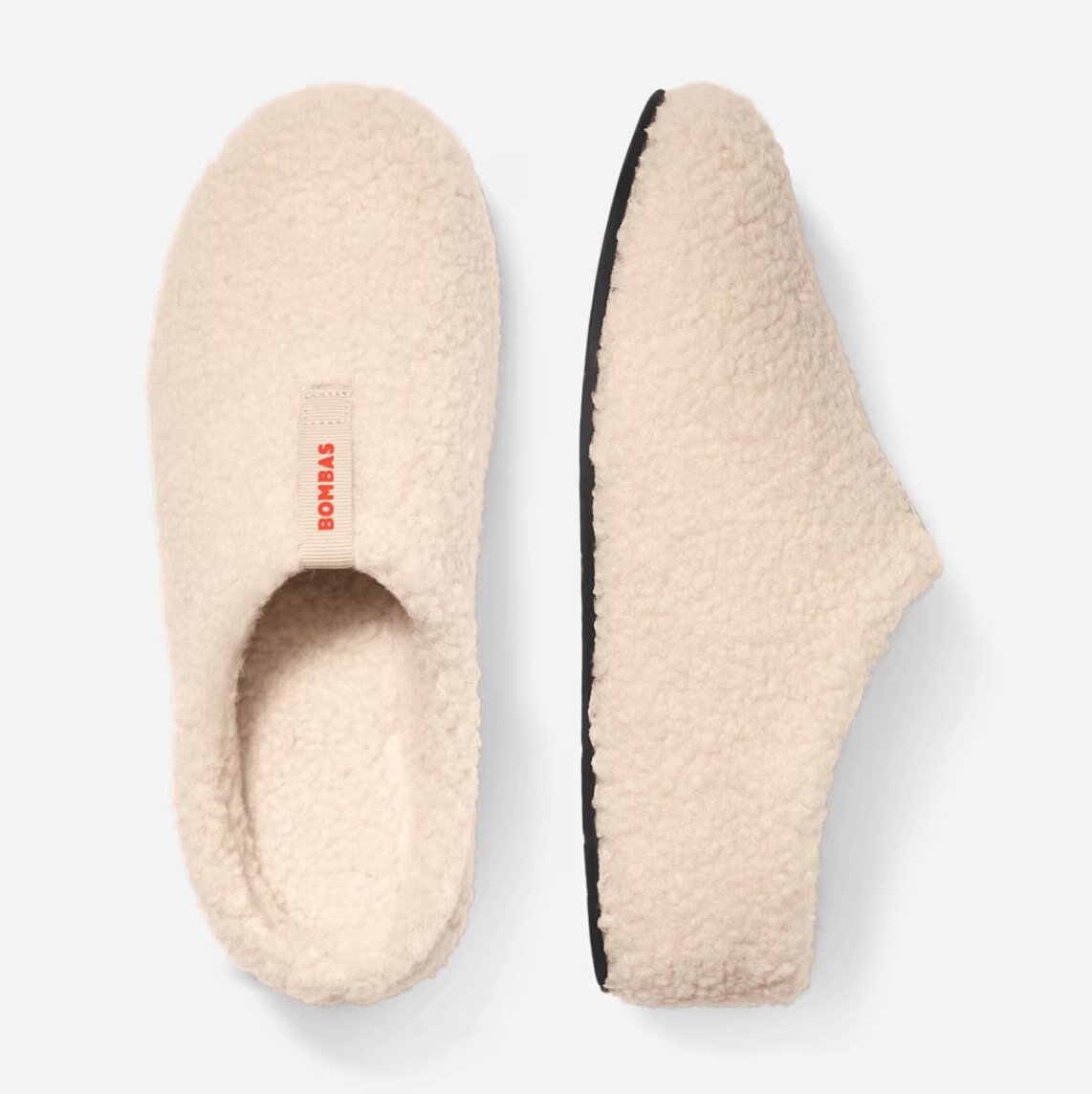 Soft, fluffy slippers made from cozy material, perfect for keeping feet warm and comfortable at home.
