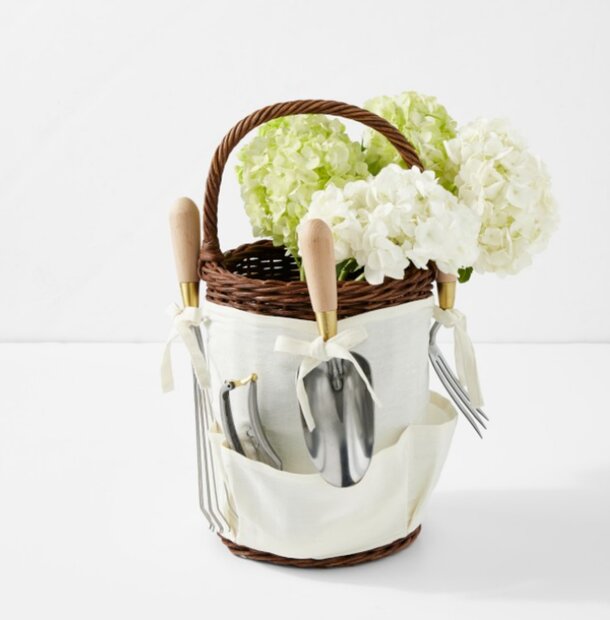 A basket filled with colorful flowers and various gardening tools, showcasing a vibrant gardening scene.