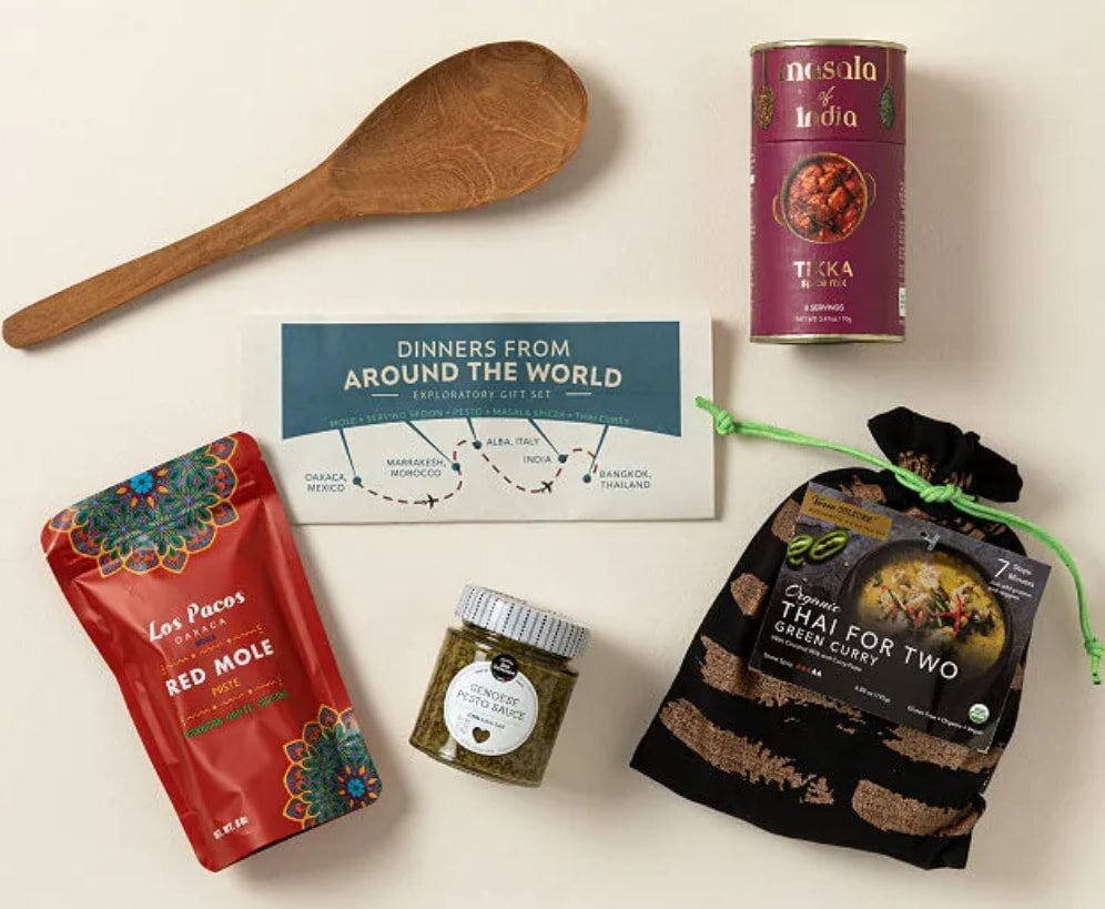 A collection of various spices arranged with a spoon, showcasing diverse colors and textures of the food items.  