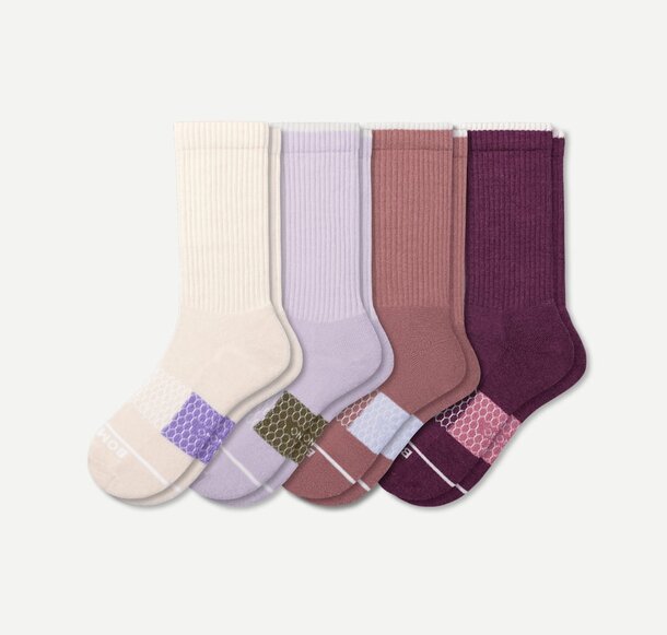 Four pairs of colorful socks displayed together, showcasing a variety of hues and patterns.