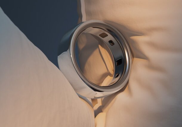 A close-up of a wedding ring resting elegantly on a soft, decorative pillow.