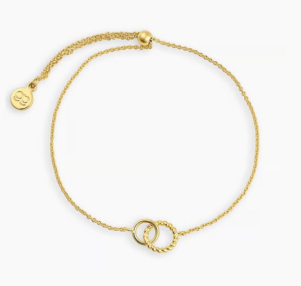 A gold bracelet featuring two intertwined hearts, symbolizing love and connection.