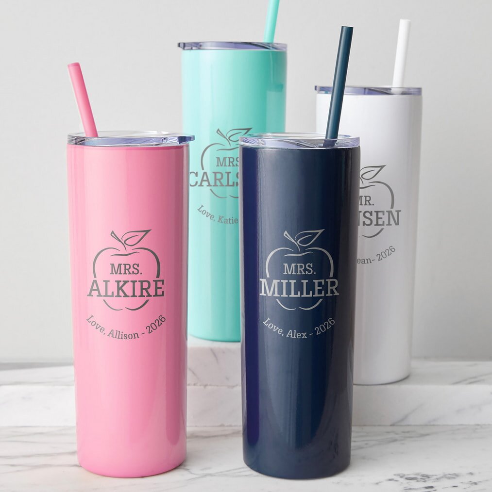 Four personalized teacher tumblers with straws on marble surface